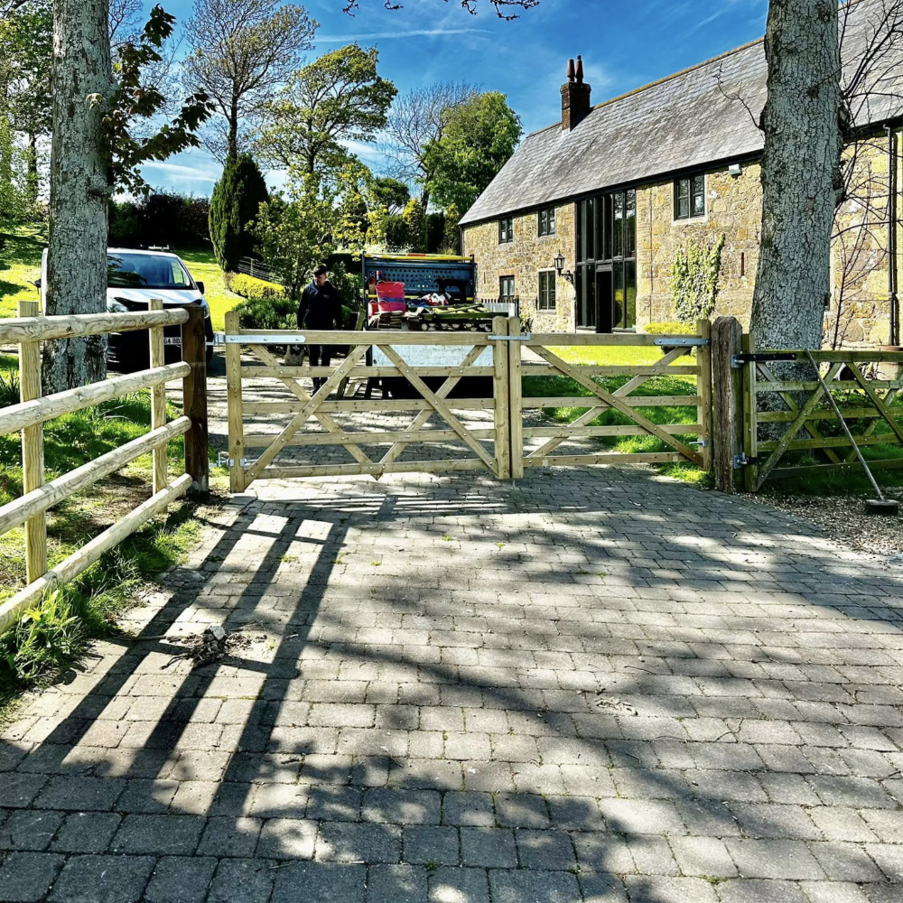 Rusting fencing around a period stone house