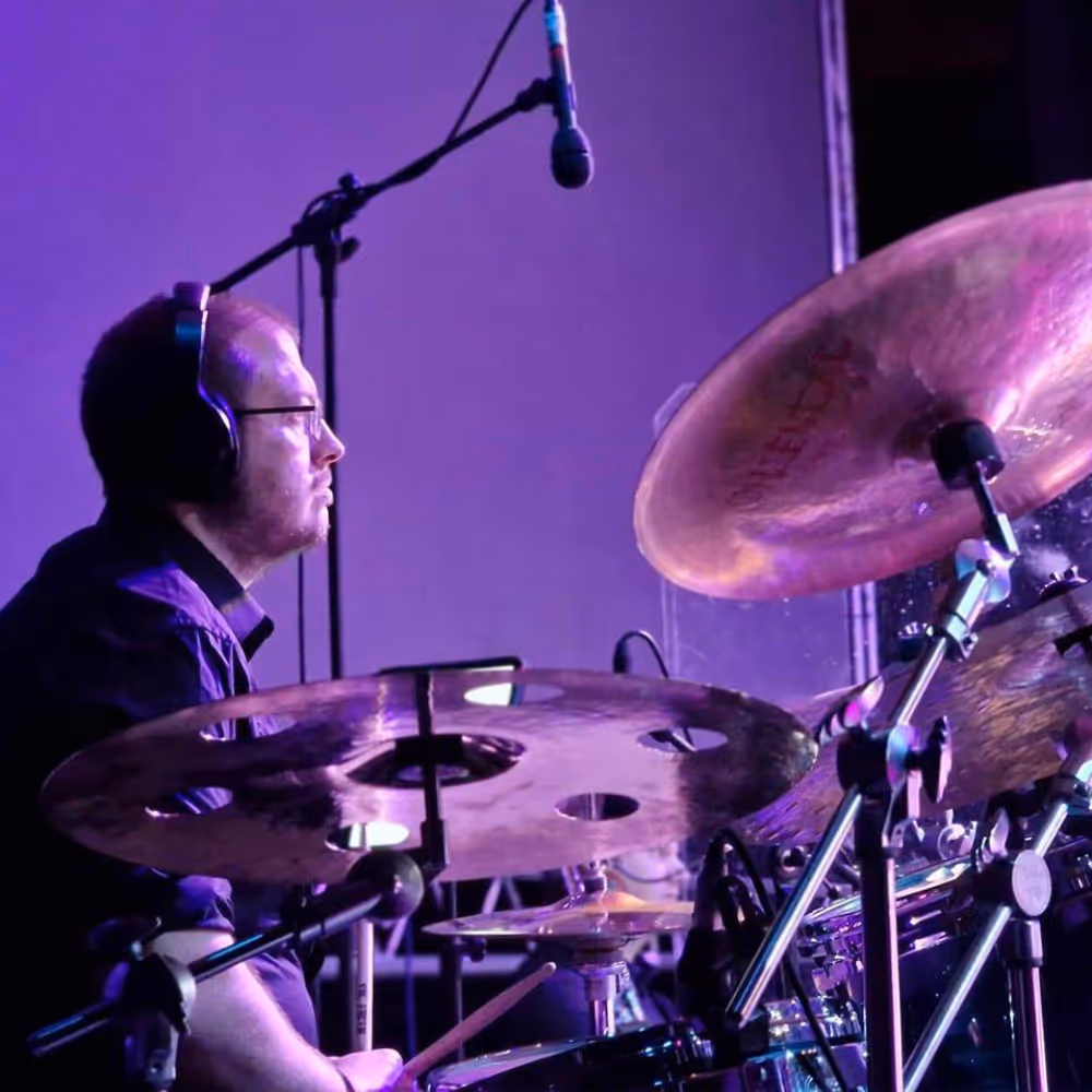 A drummer playing in a gig.