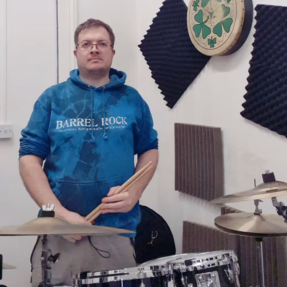 A drummer sitting at his kit.