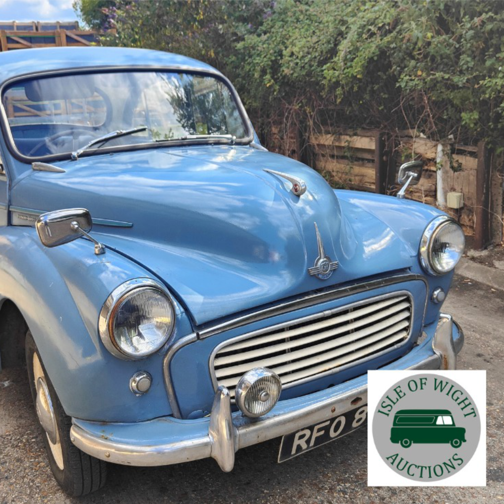 An old light blue Morris car.