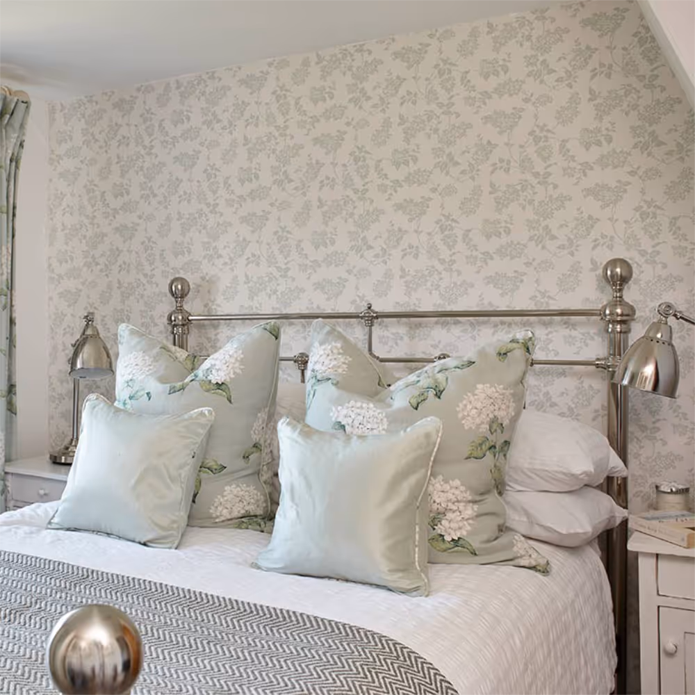 A pretty country styled bedroom with brass bedstead.