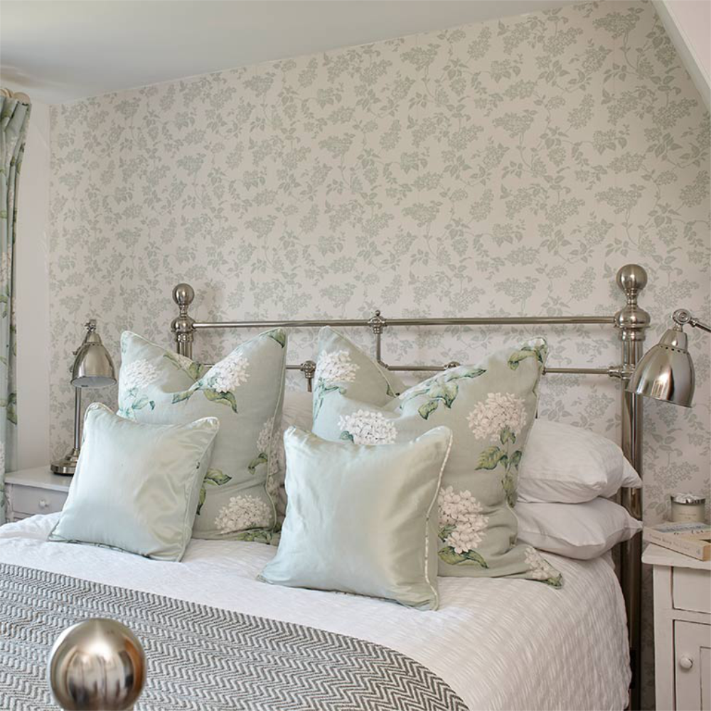 A pretty country styled bedroom with brass bedstead.