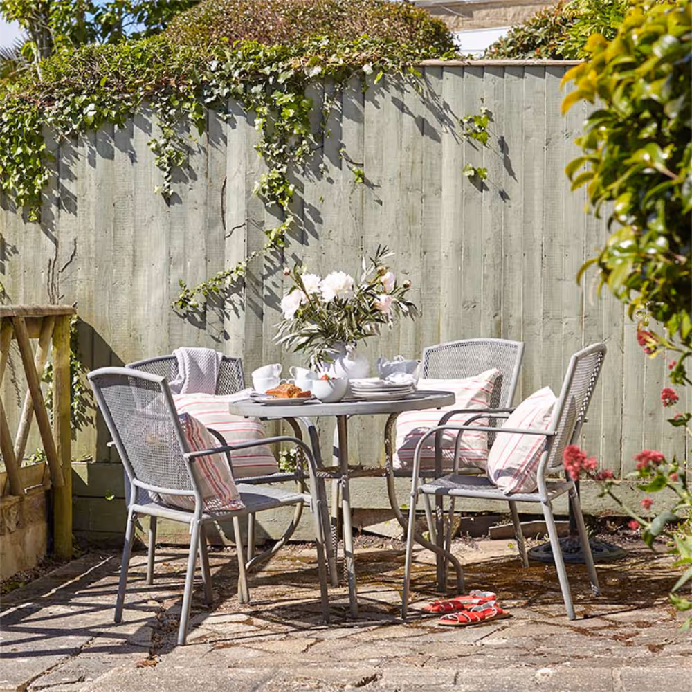 Metal garden furniture in a sunny corner of a garden.
