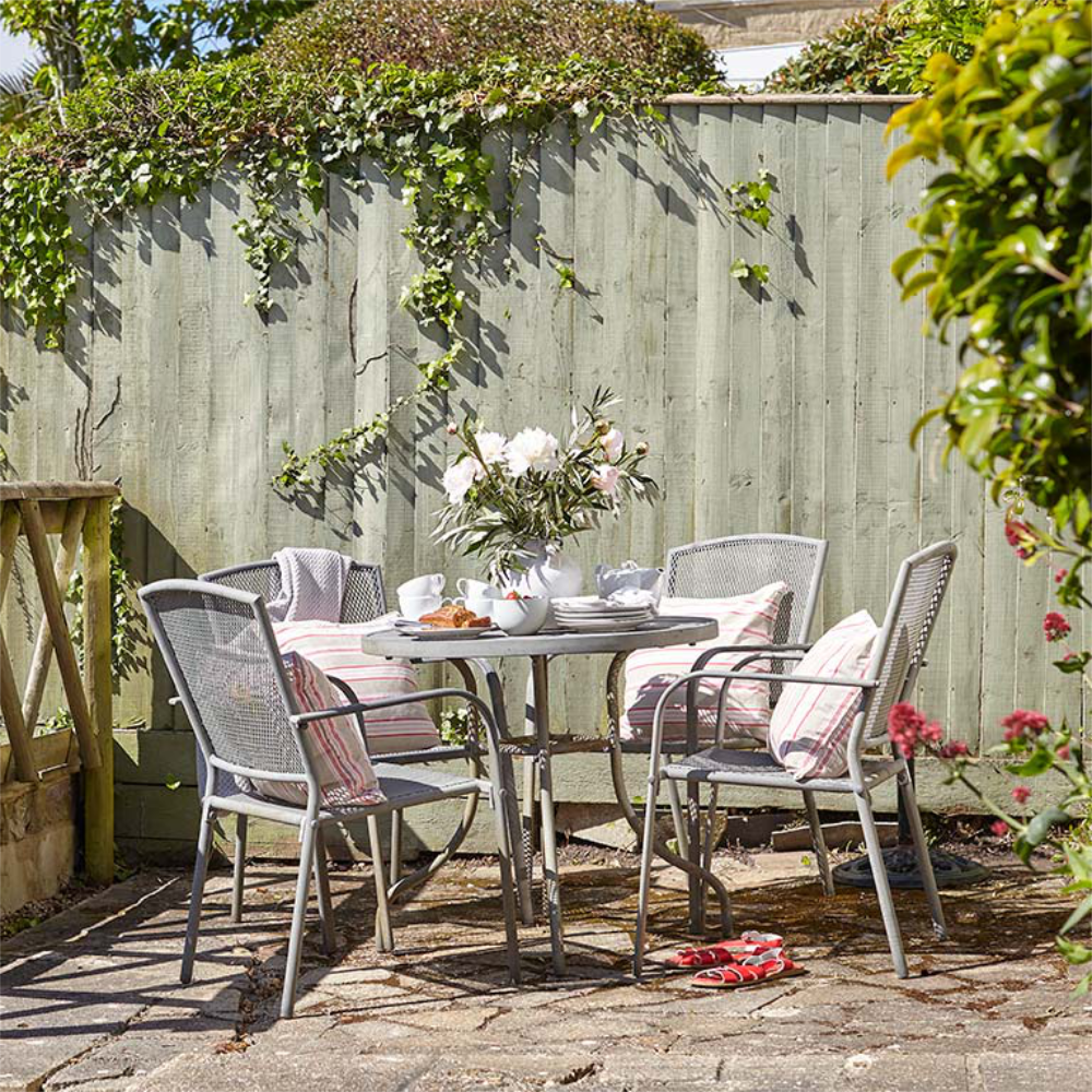 Metal garden furniture in a sunny corner of a garden.