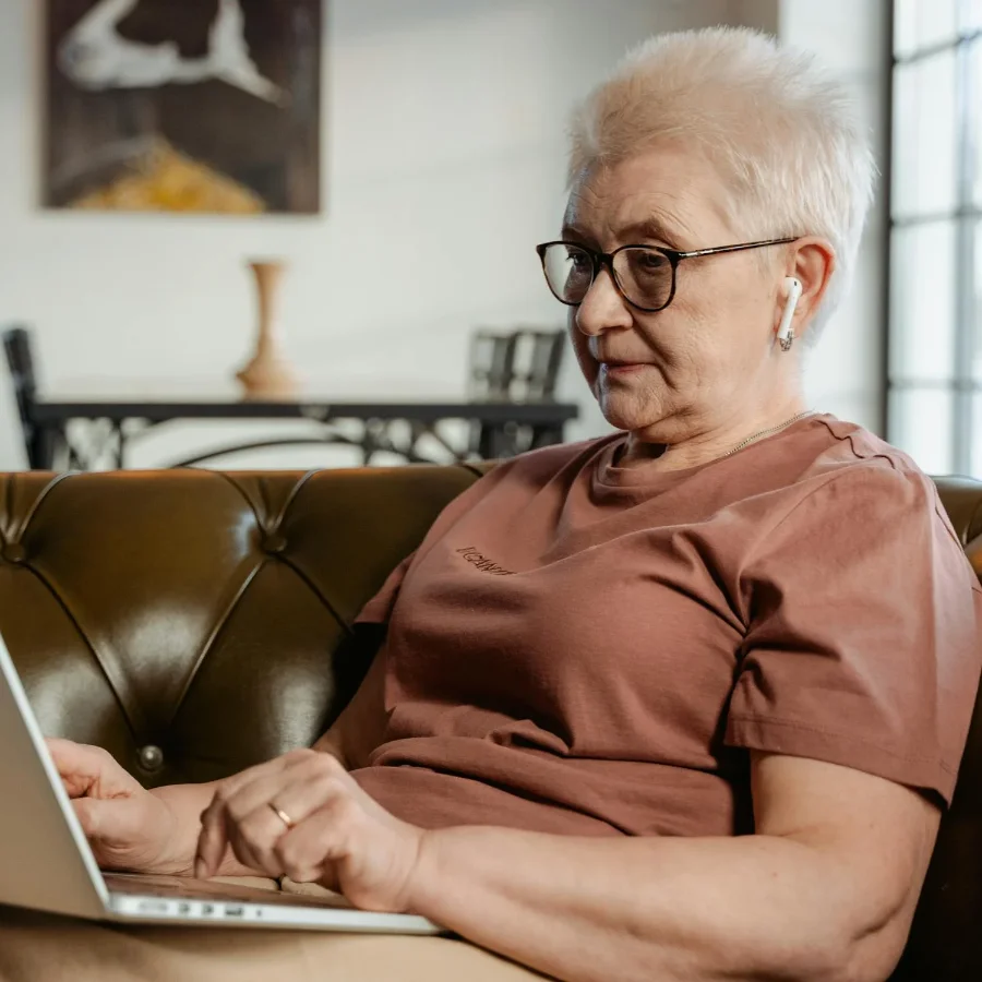 A woman typing on a laptop.