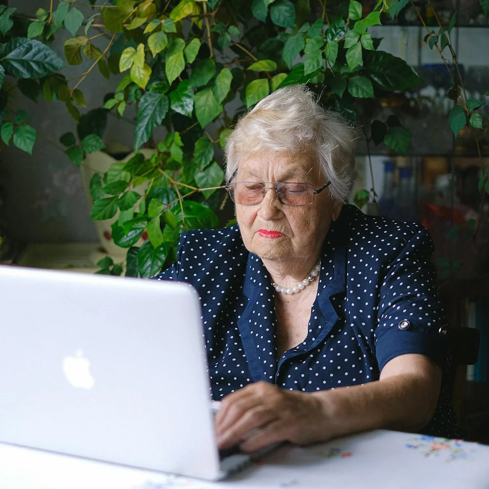A woman looking at a laptop.