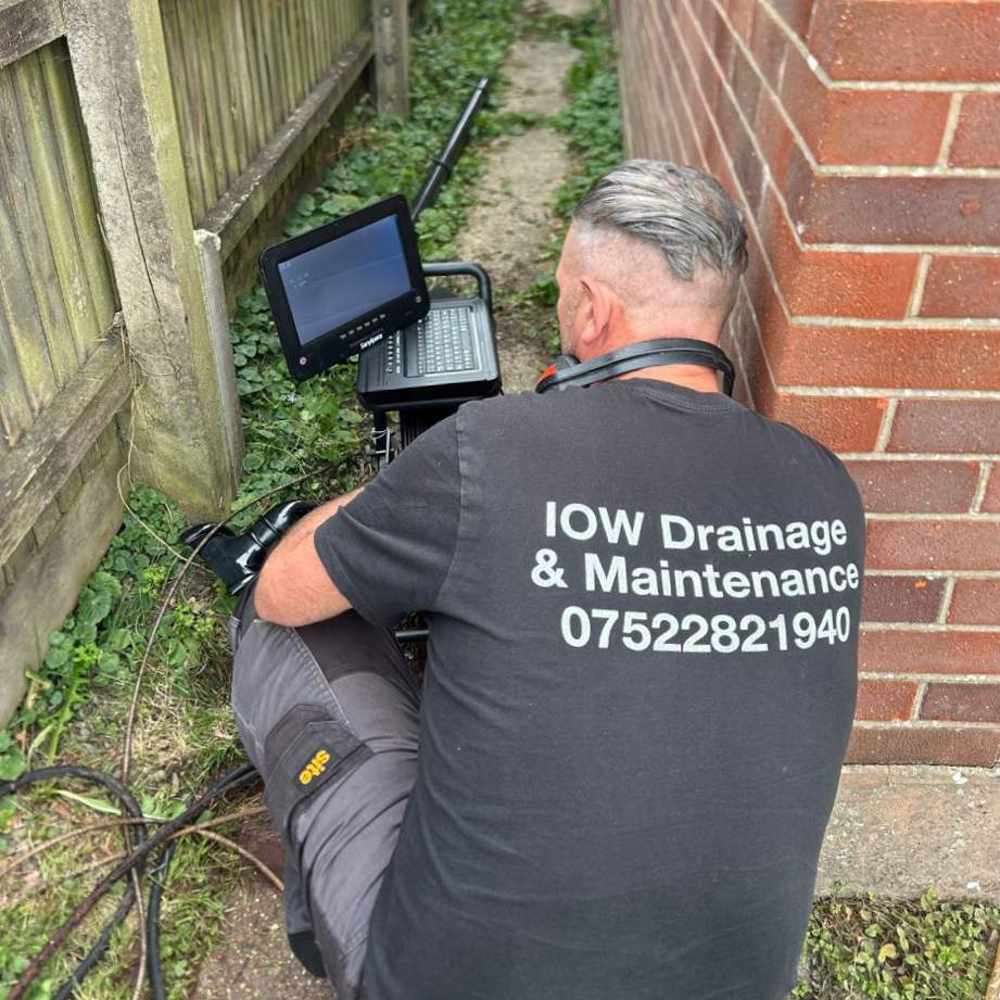 A man using equipment to diagnose a blocked drain