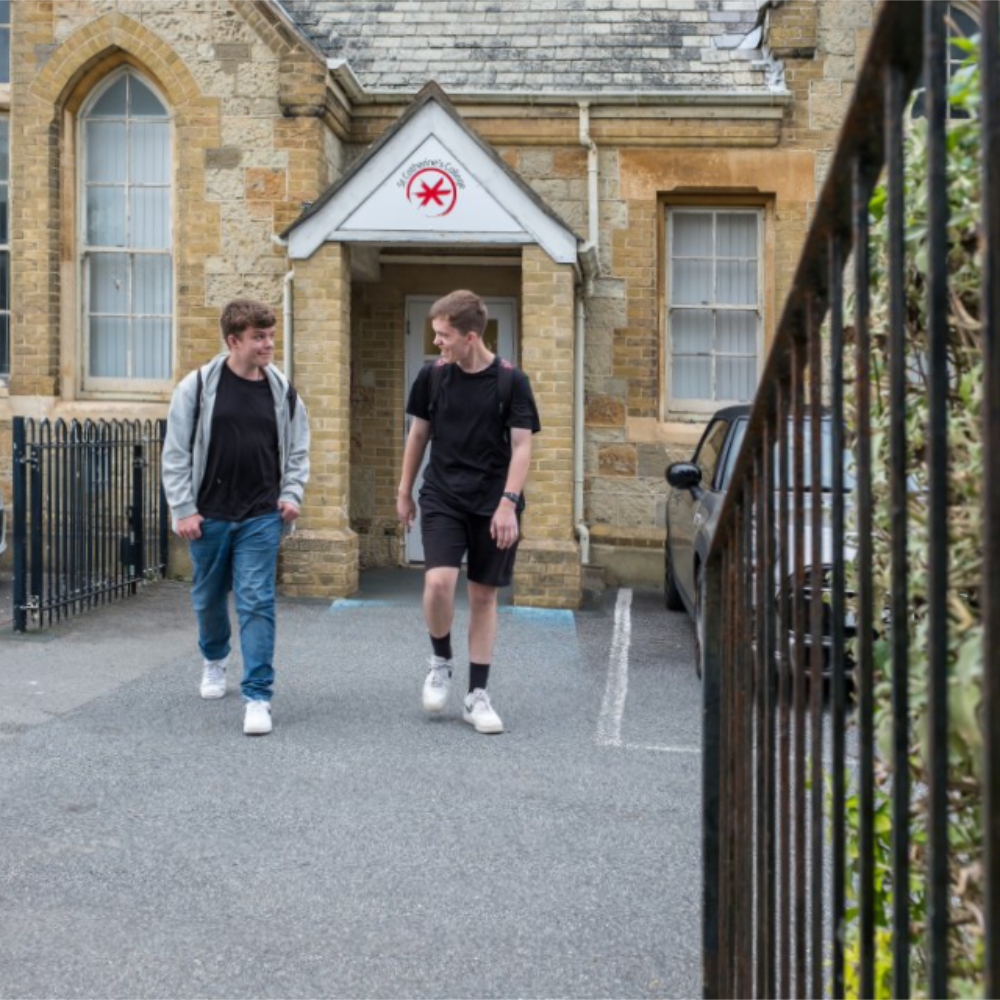 Two male students walking through the carpark of a college
