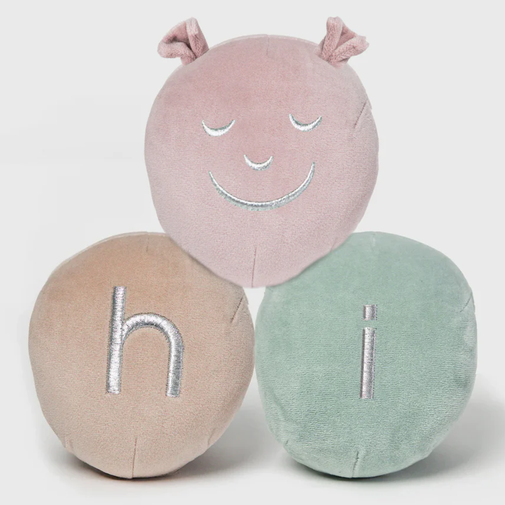 A soft velvet personalised caterpillar for a baby's cot
