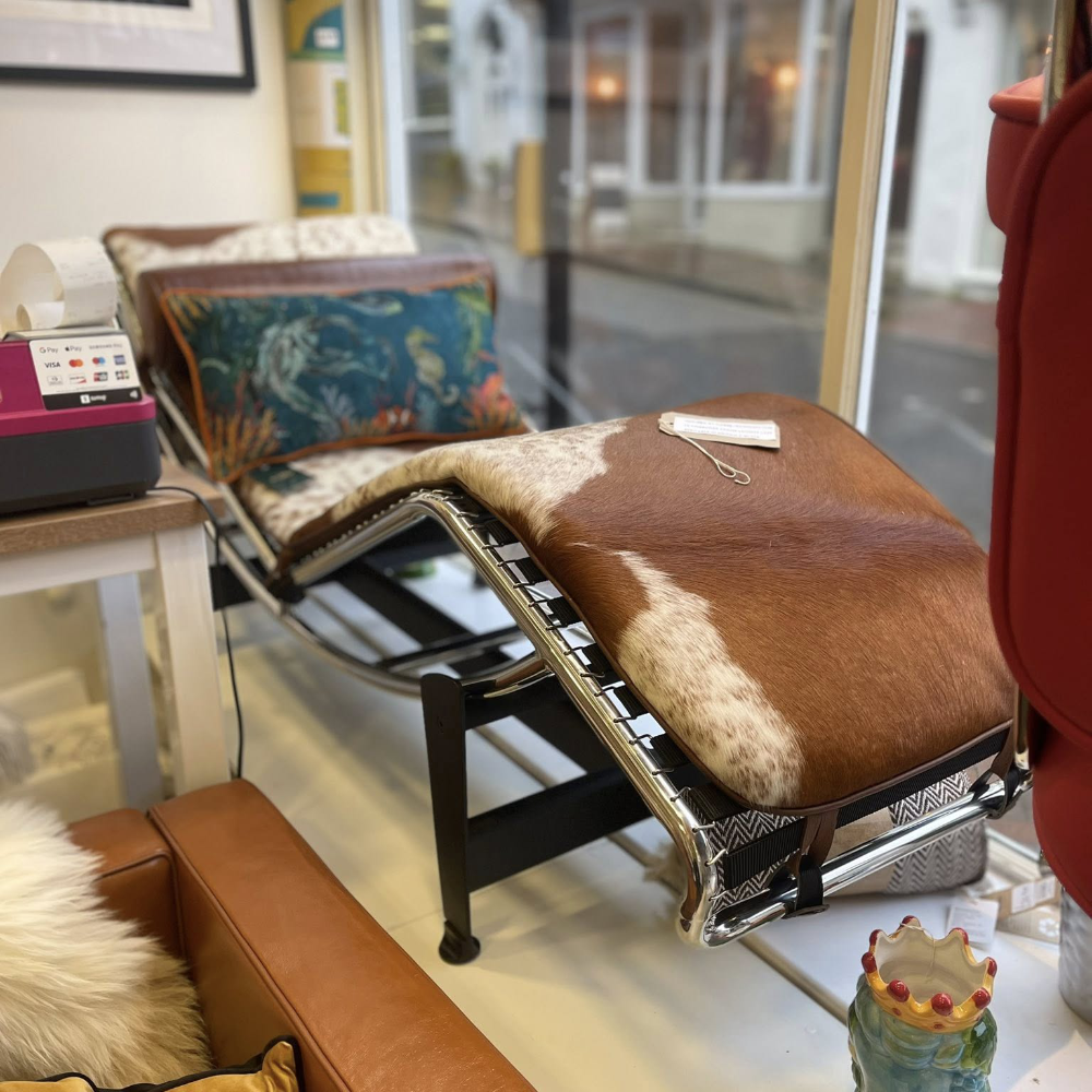 A Le Corbusier style leather and chrome chair longue in a shop