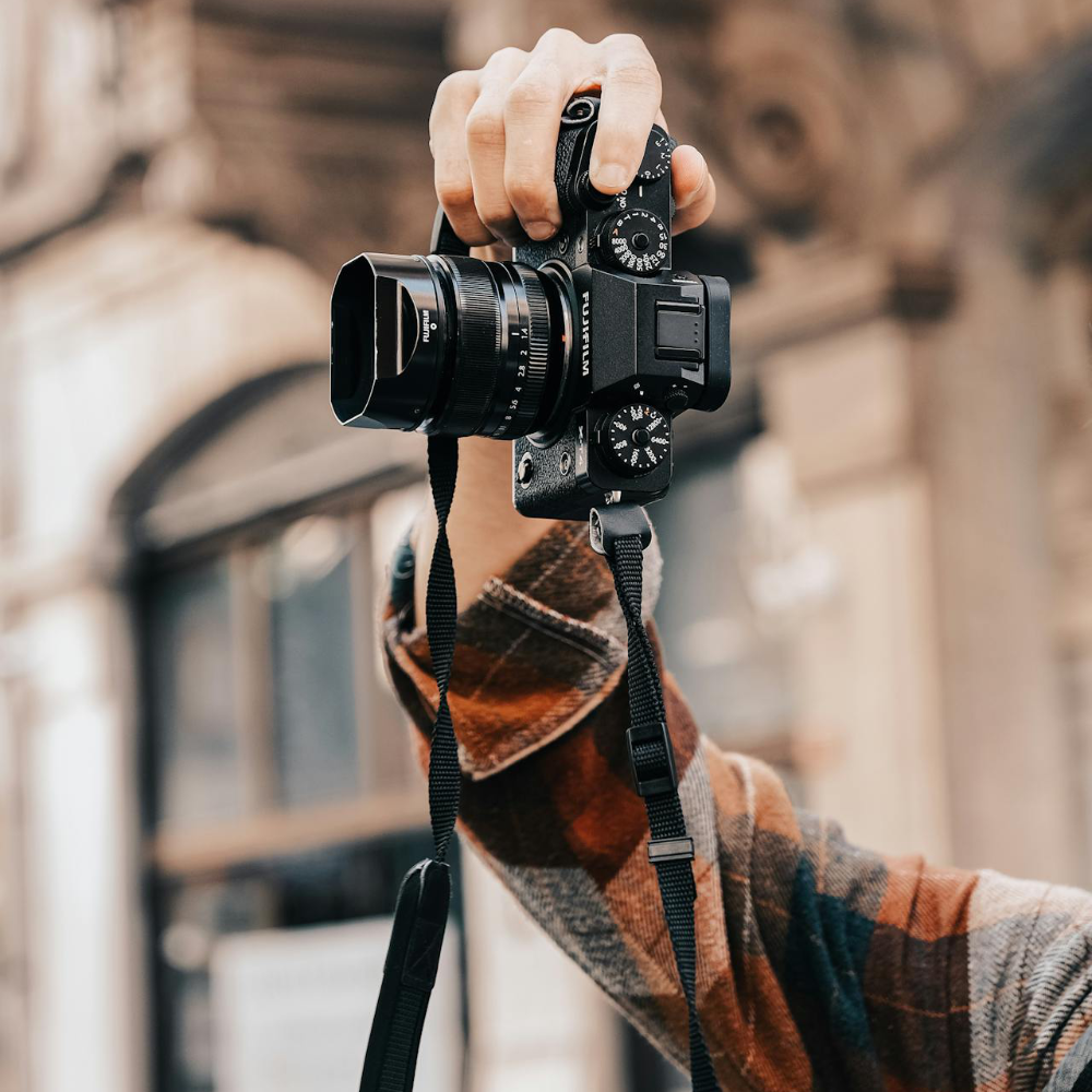 An SLR camera held in the air.