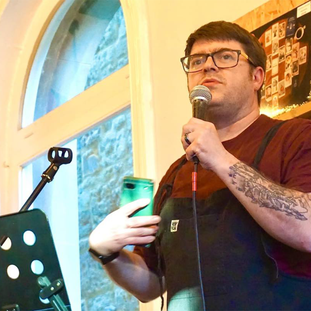 A man performing at an open mic event.