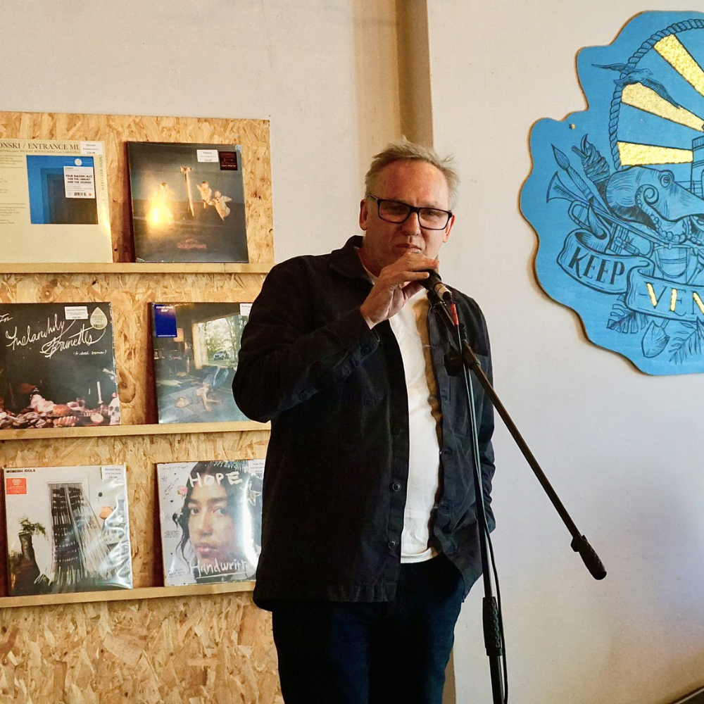 A man performing at an open mic event.