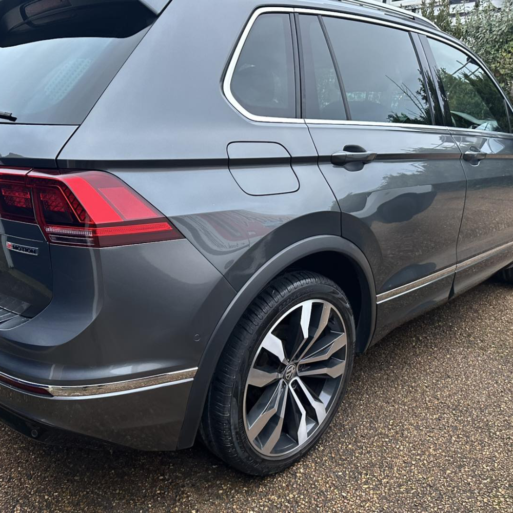 The rear quarter of a silver grey car