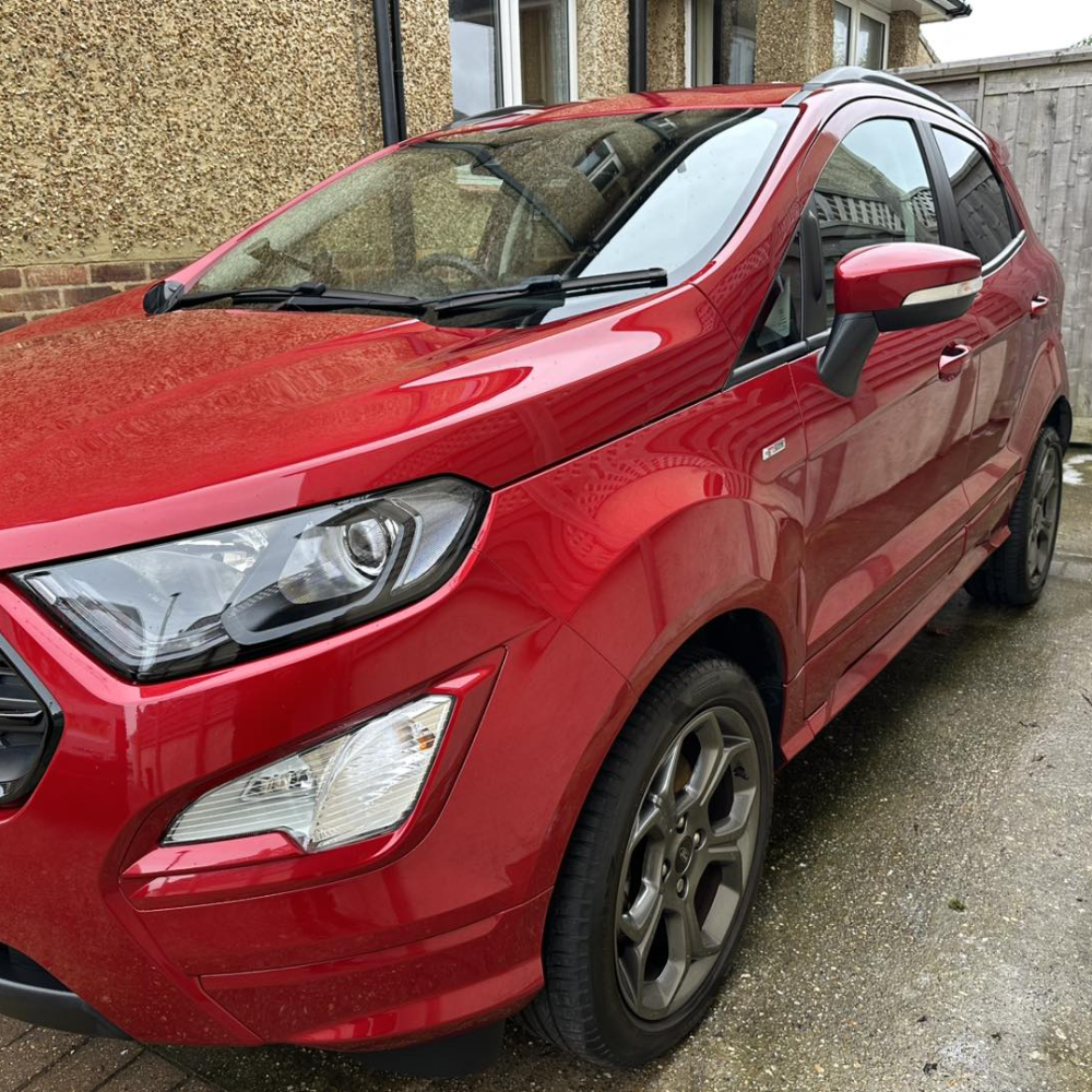 The front quarter of a red car