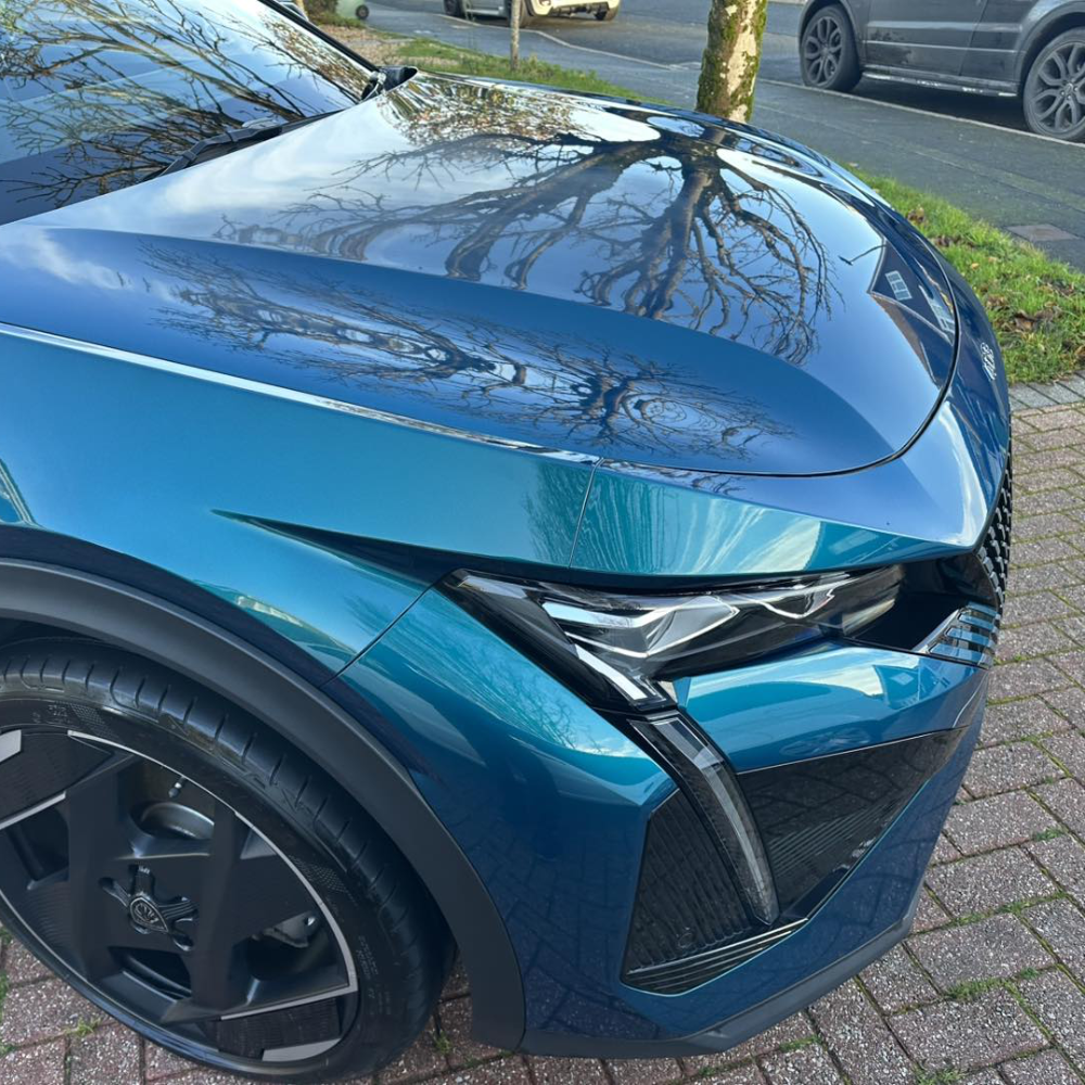 The front quarter of a bright blue car