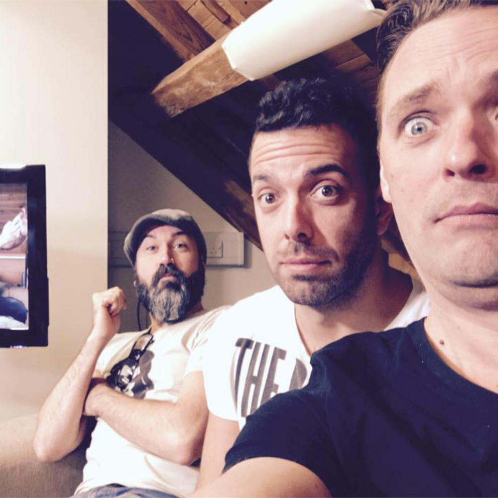 A team of 3 men in a comical selfie.
