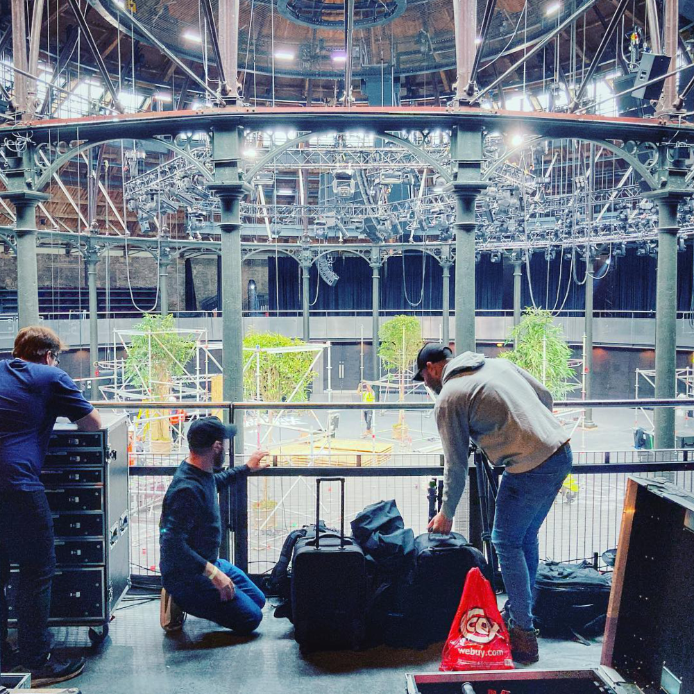 Film crew setting up at a music venue.