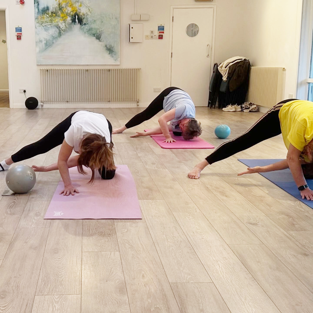 Three women in a pilates class