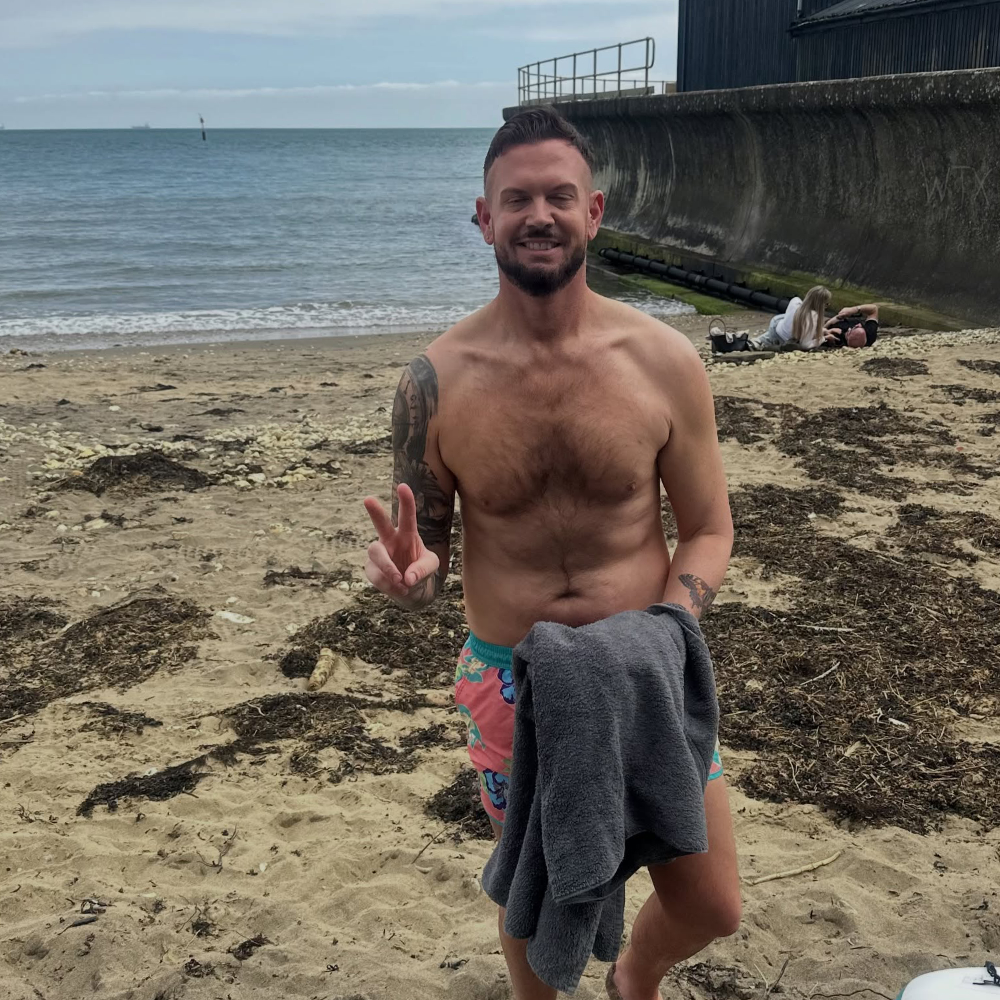 A man wearing shorts on a beach