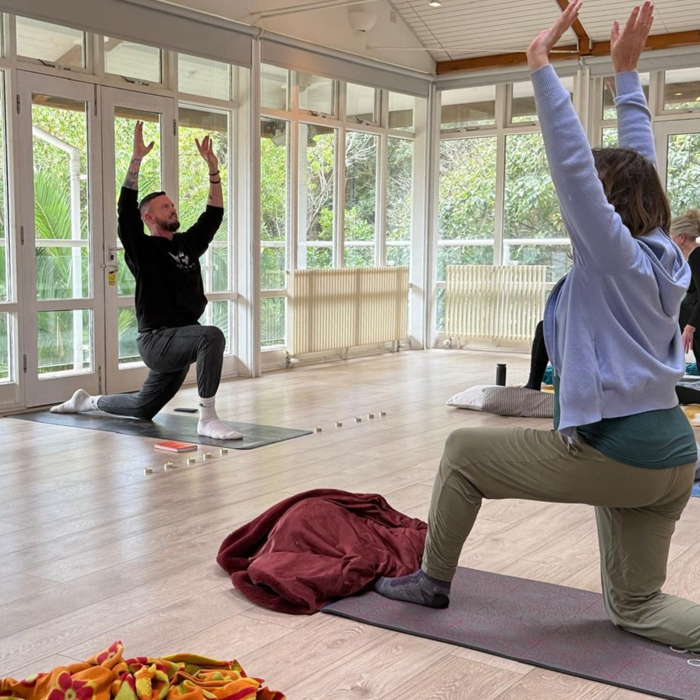 A man teaching a yoga class