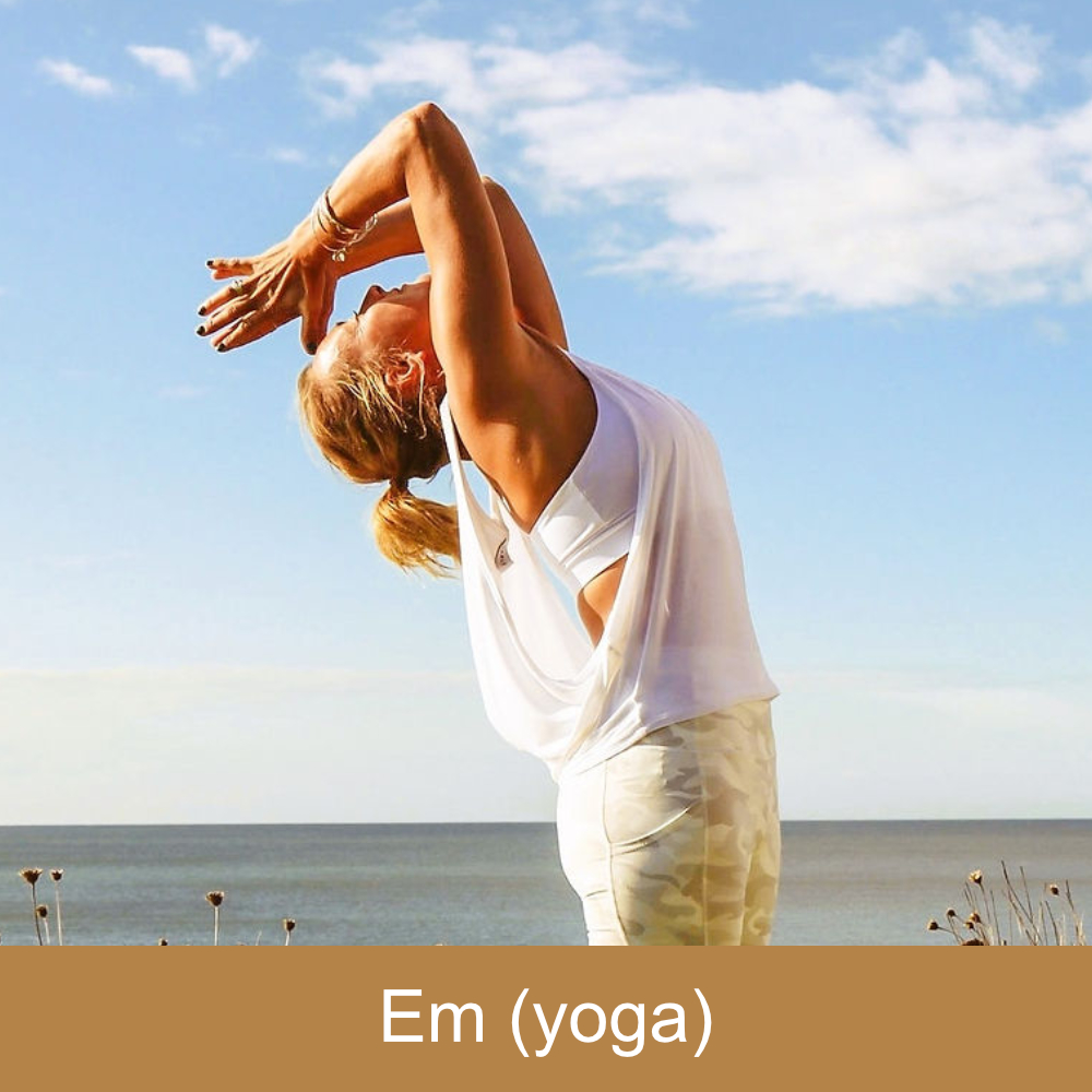 A lady in a yoga pose on a beach.