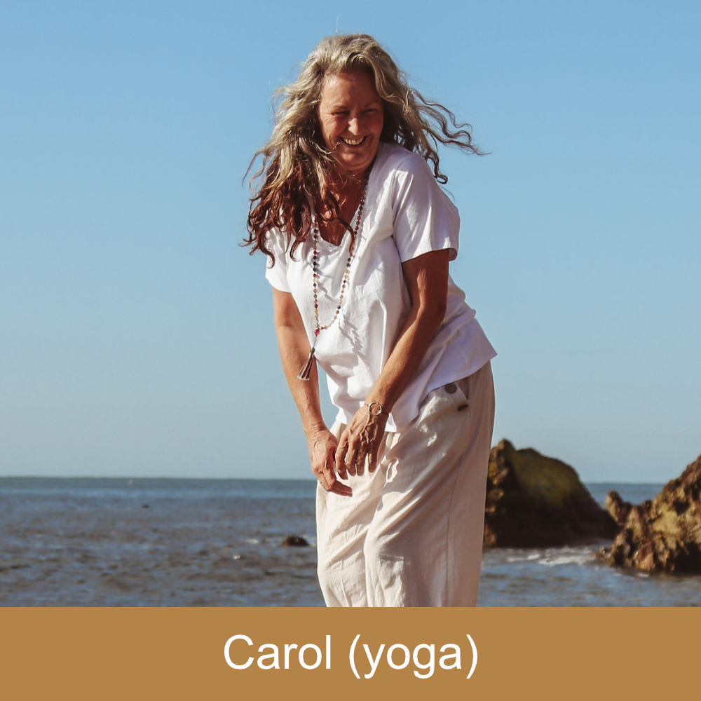 A lady practicing yoga on a beach.