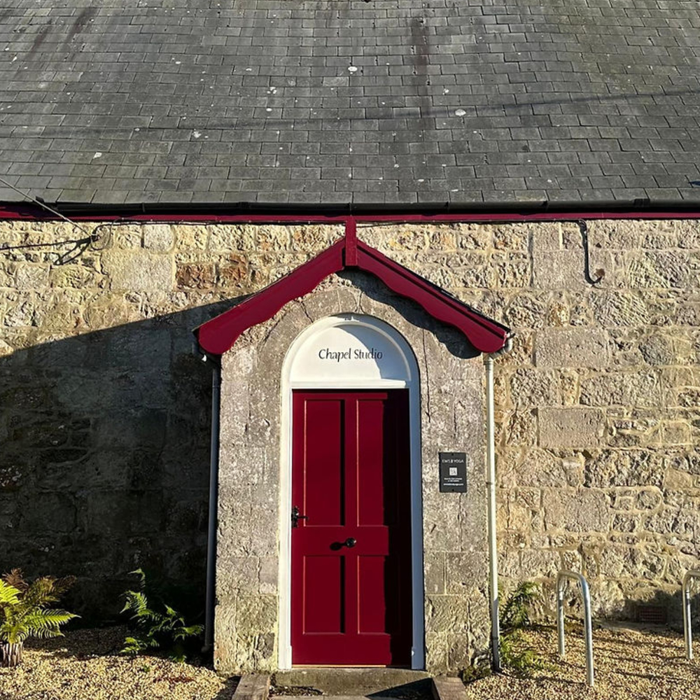 An old chapel with a red front door.