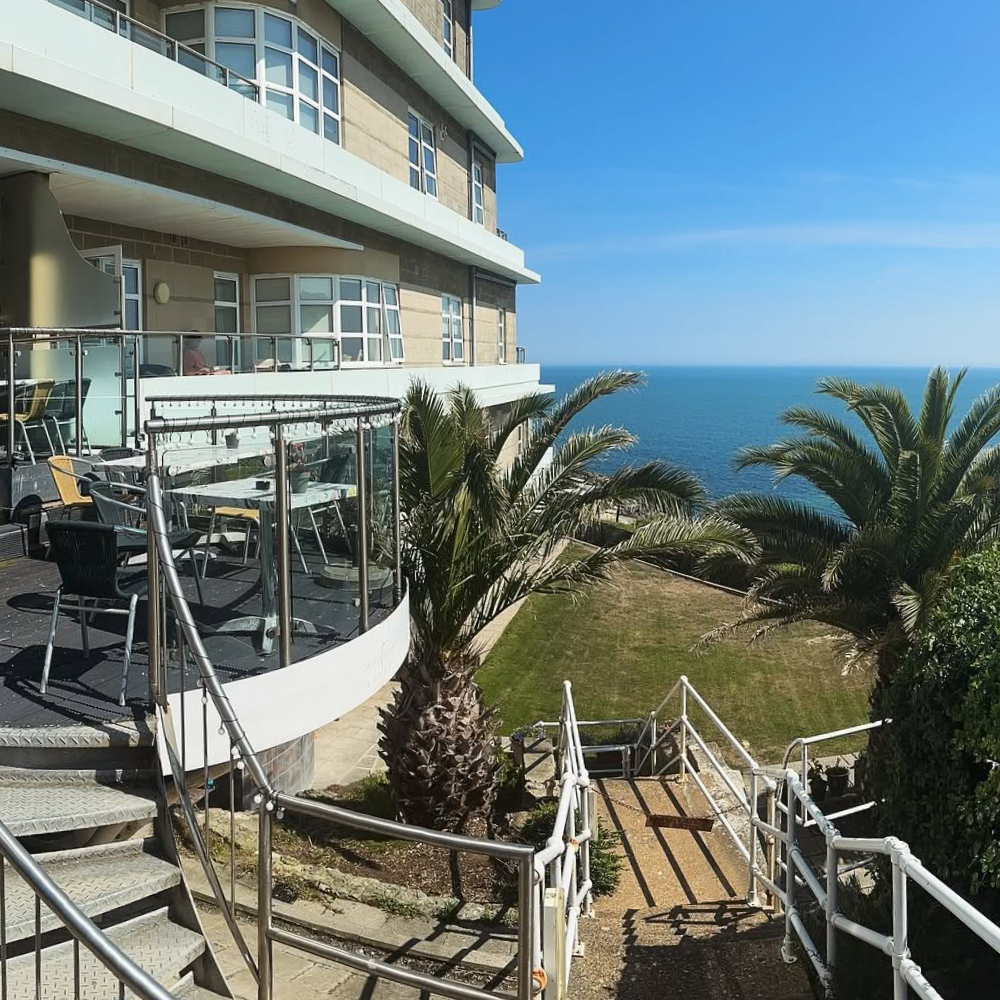 The outside terrace of a seaside restaurant.