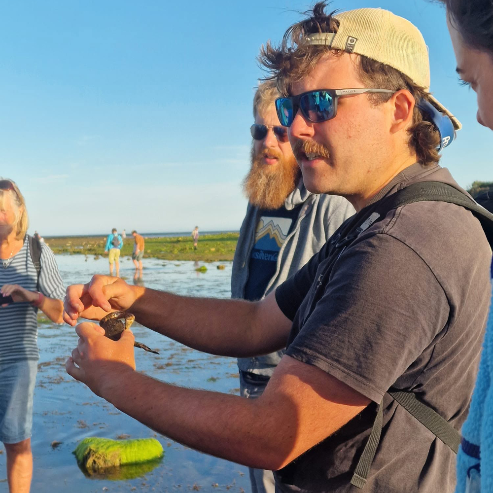 A man giving a talk on sealife in a nature reserve.