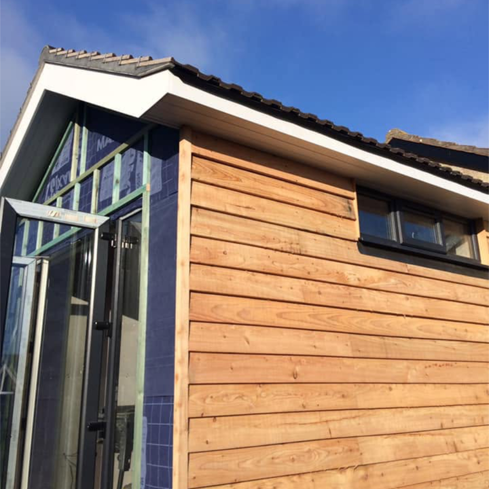 A house being clad in wood.