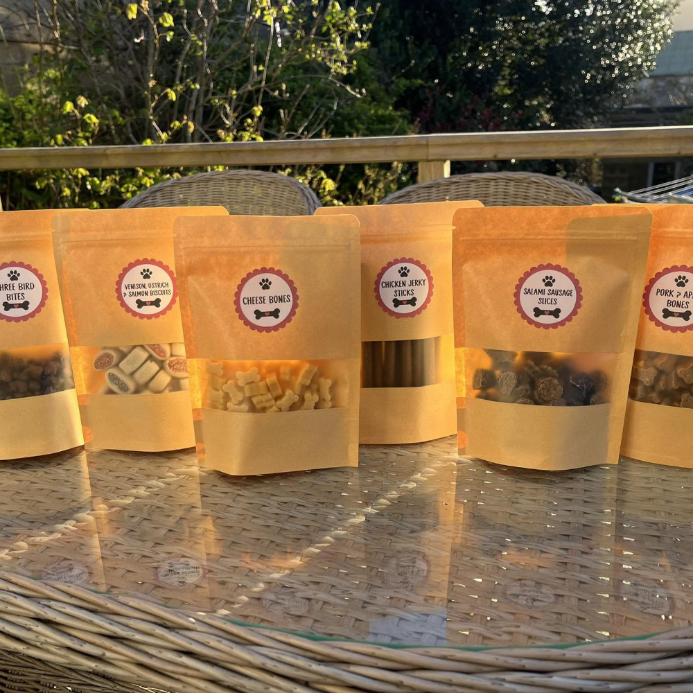 Bags of dog treats on a table.