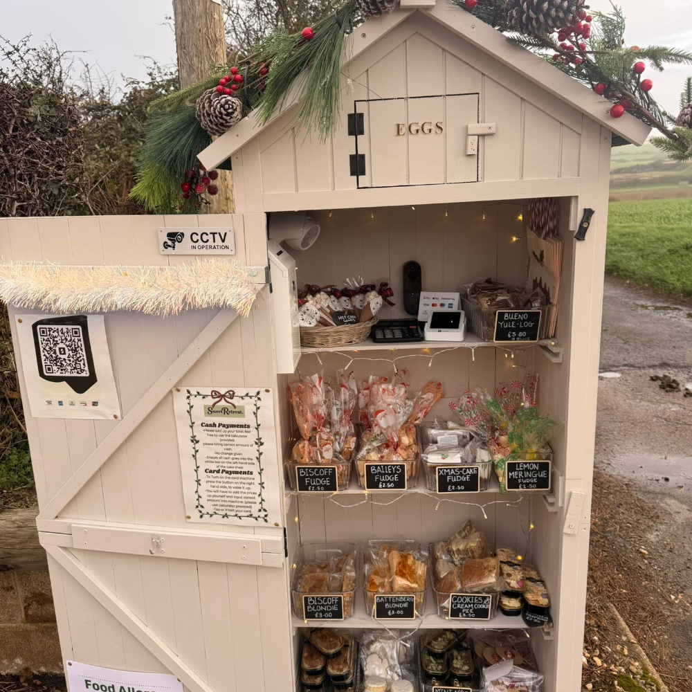 A small roadside shed with cakes for sale.