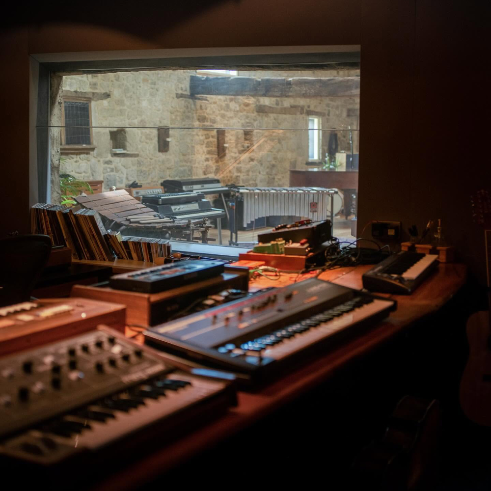 Equipment in a music studio within a converted barn.