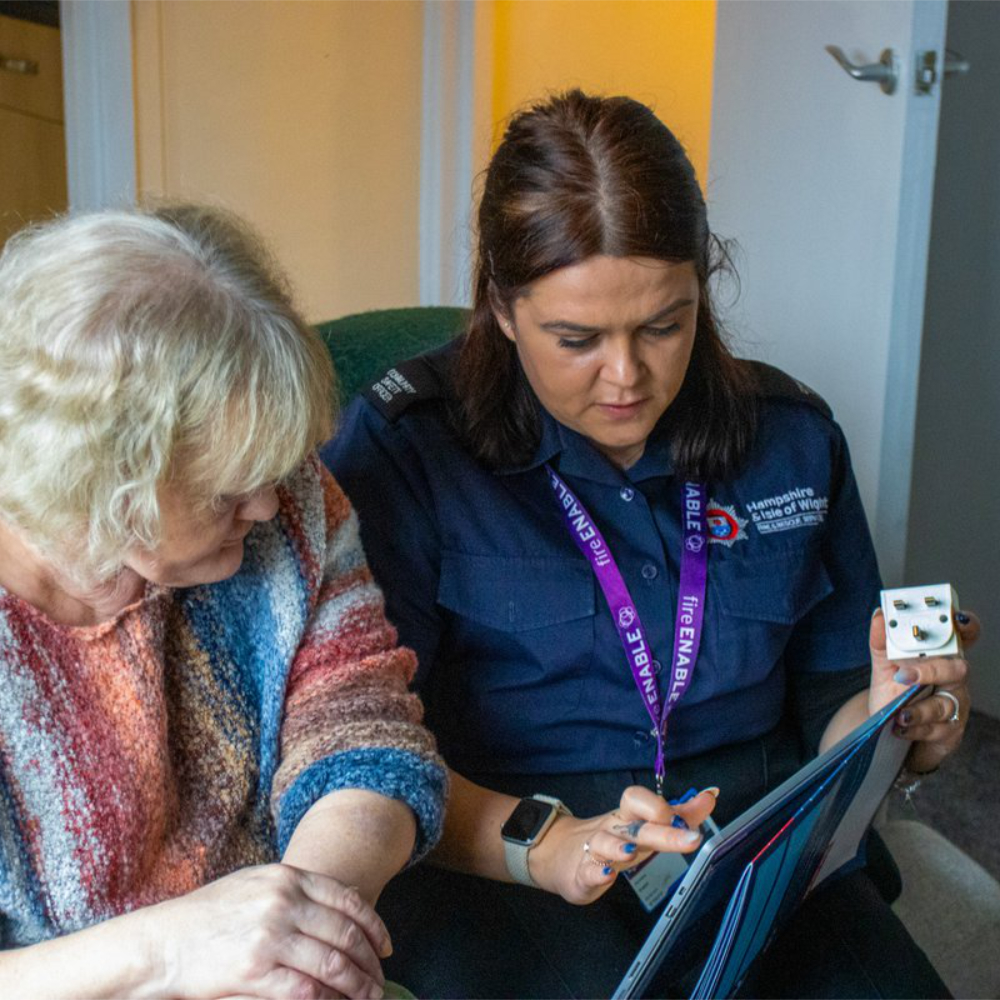 A fire officer explaining safety to a homeowner.
