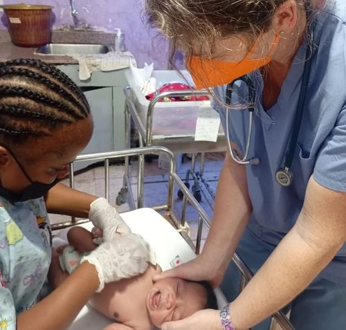 Nurse providing care to an infant in the NICU