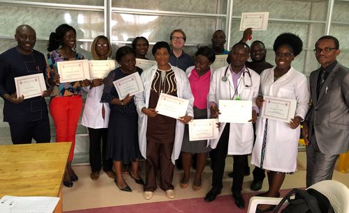 Group of Liberian physicians presenting their training certificates