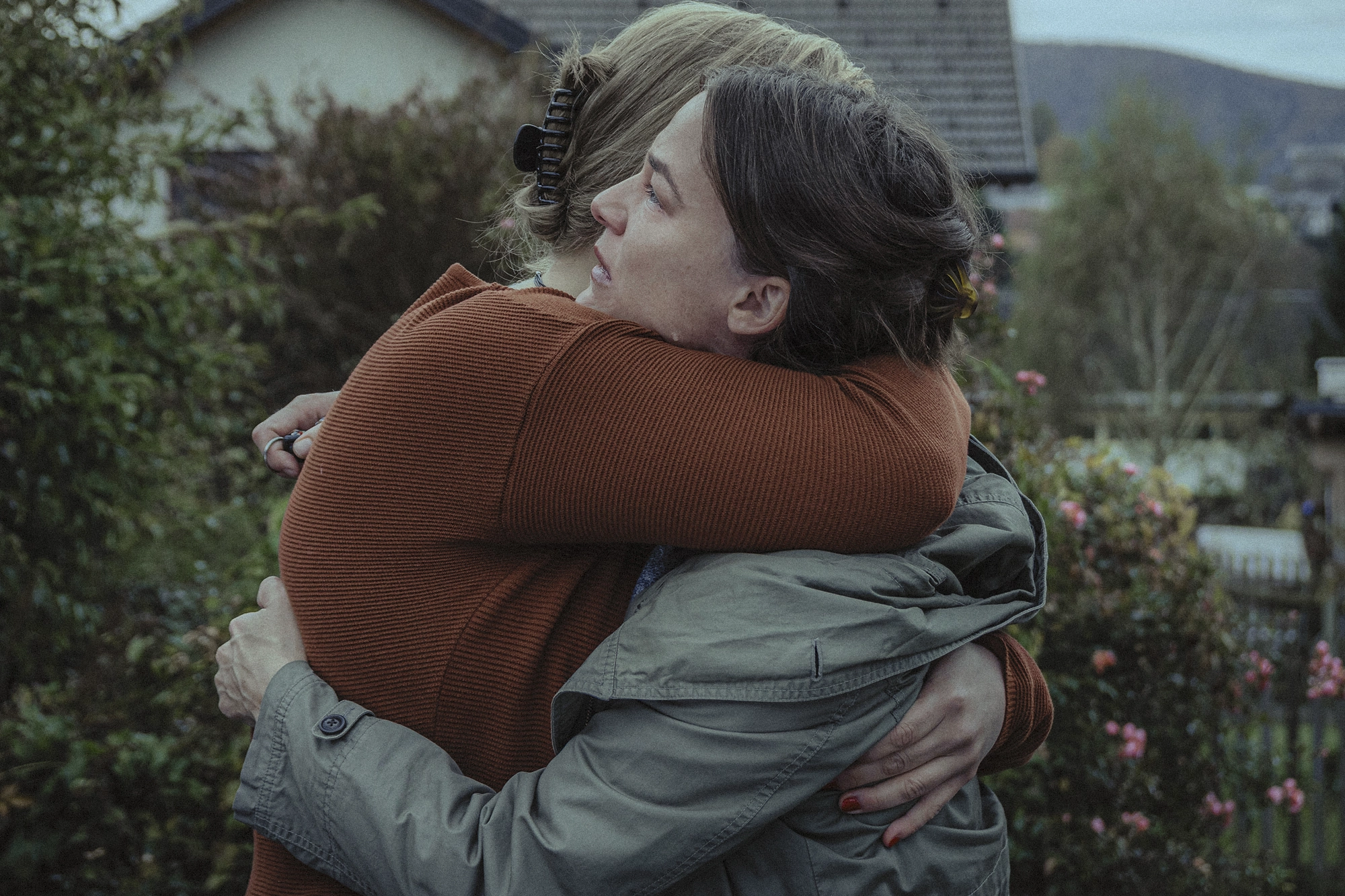 Film Still from movie Four Minus Three (Vier Minus Drei). Two women are hugging(actress Valerie Pachner and actress Stefanie Reinsperger)