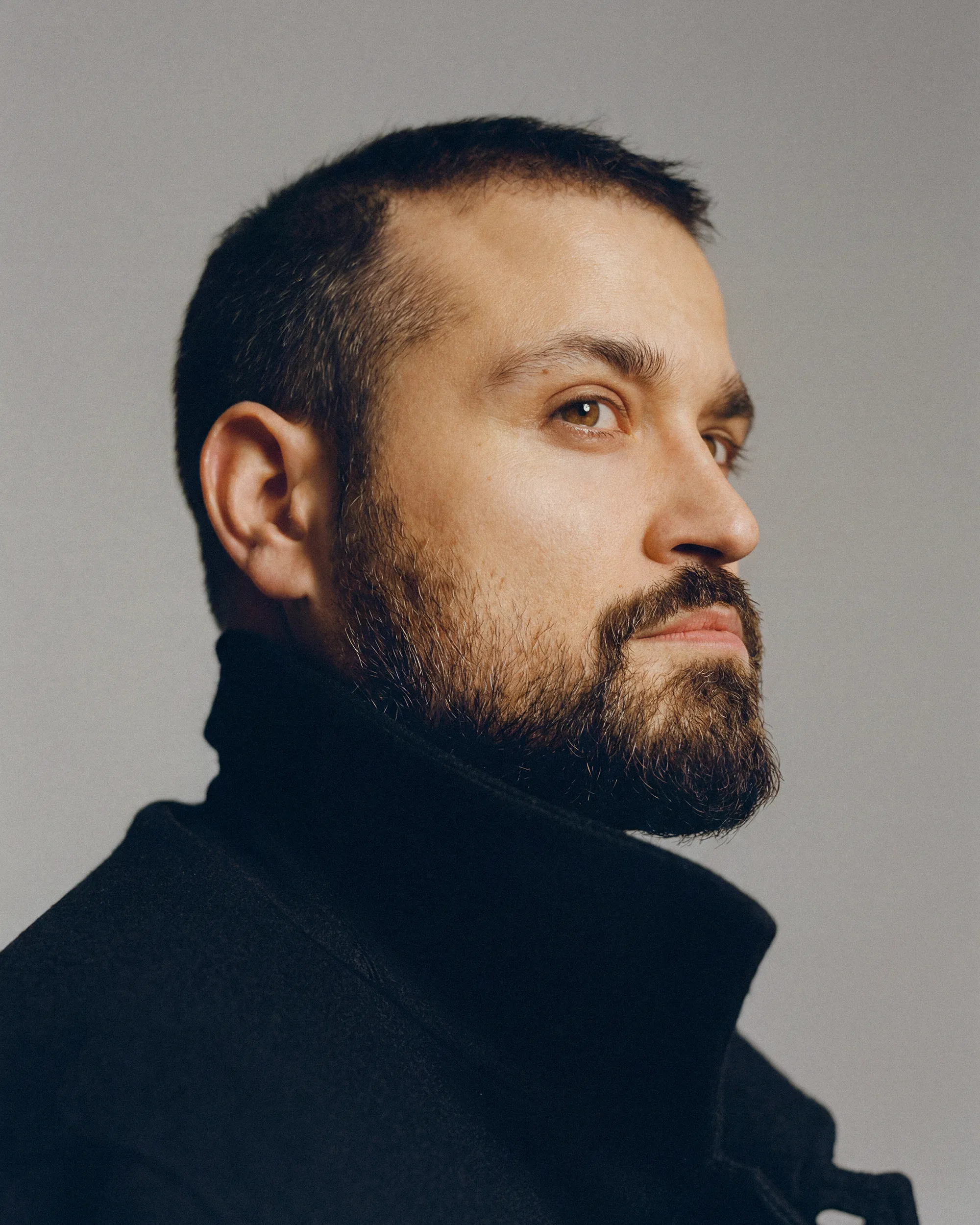 Portrait of German actor Nicolas Fethi Türksever in a studio.