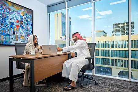 A colleague at work in the Riyadh office, overlooking the city