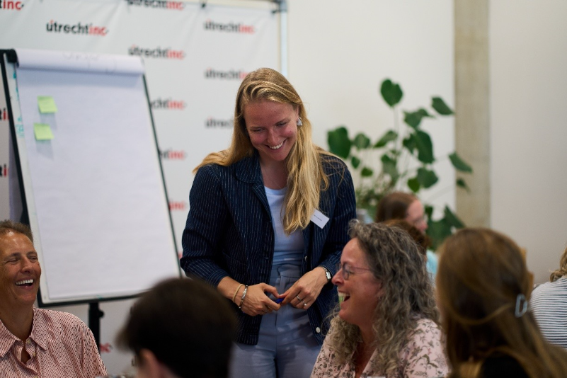 A person standing in front of a group of peopleDescription automatically generated