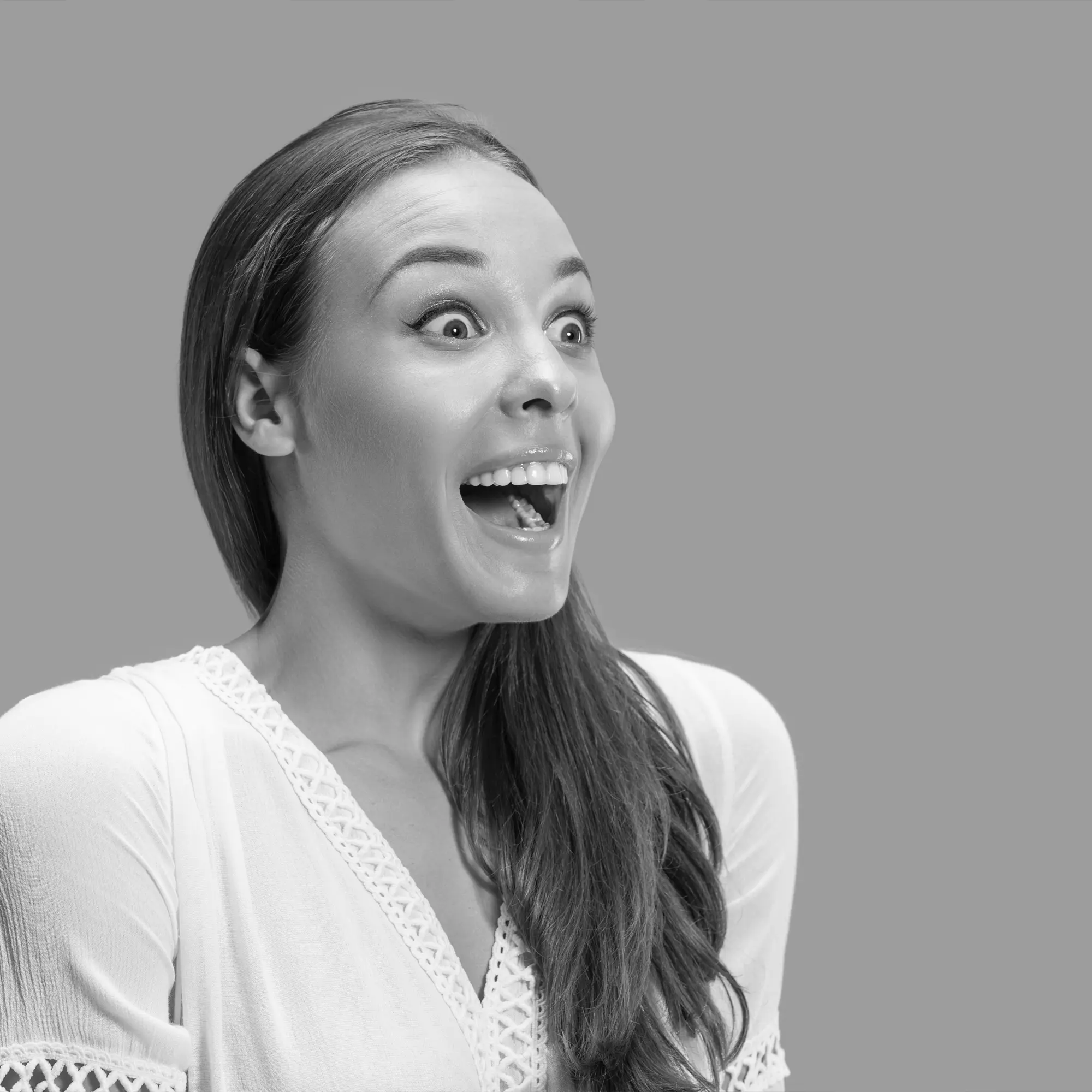 A smiling, delighted person, in black and white