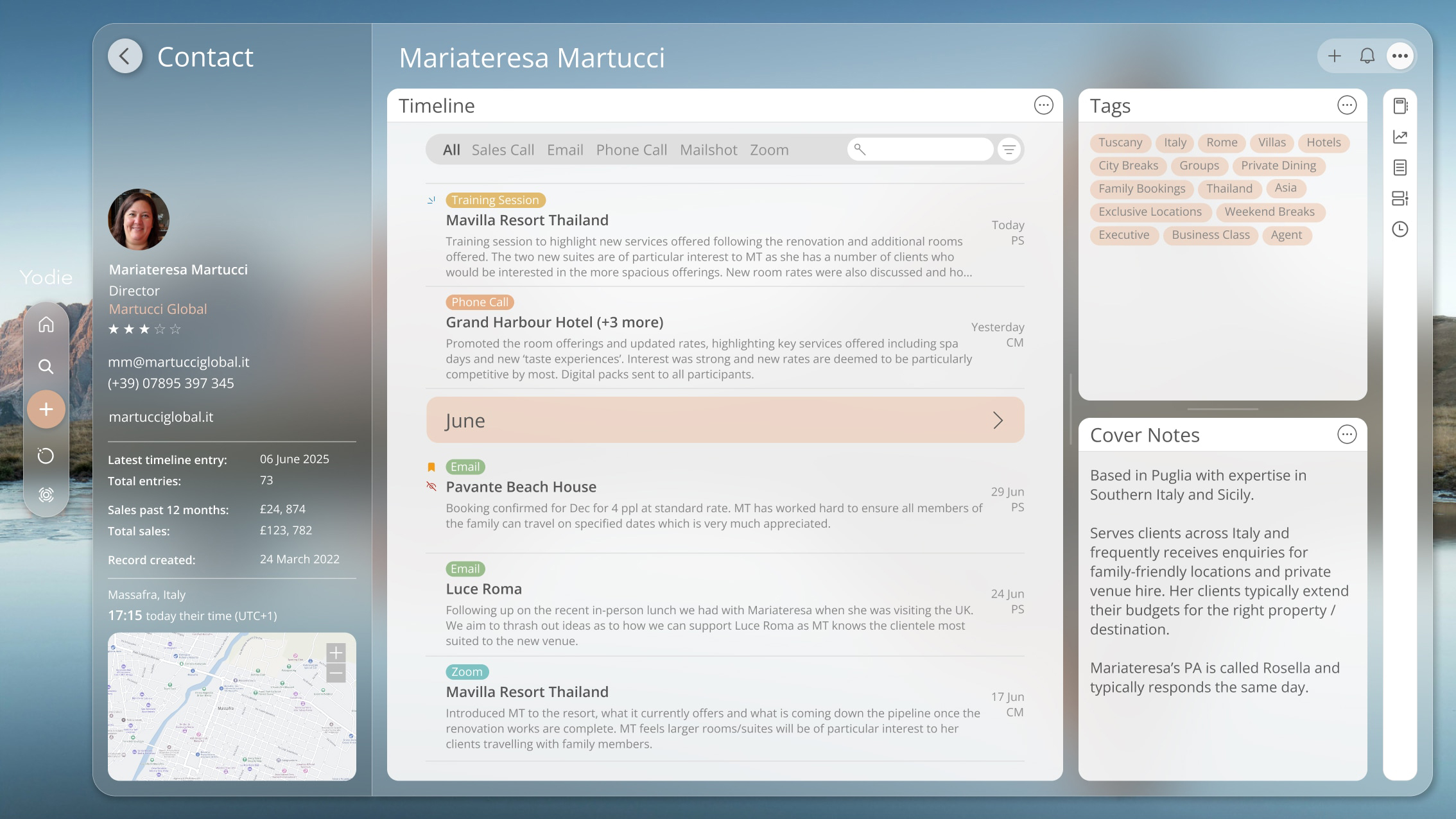 An overview screen in Yodie 6 showing a sleek glass interface and contact details with a mountain image behind.