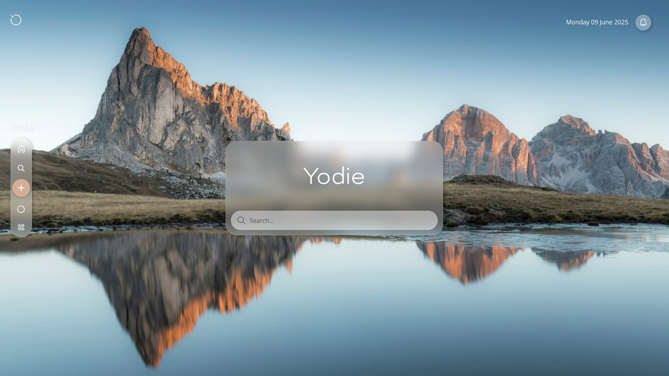 The new Yodie home screen features a glass panel and search bar centred on screen with a blue sky and mountains reflected in a lake.