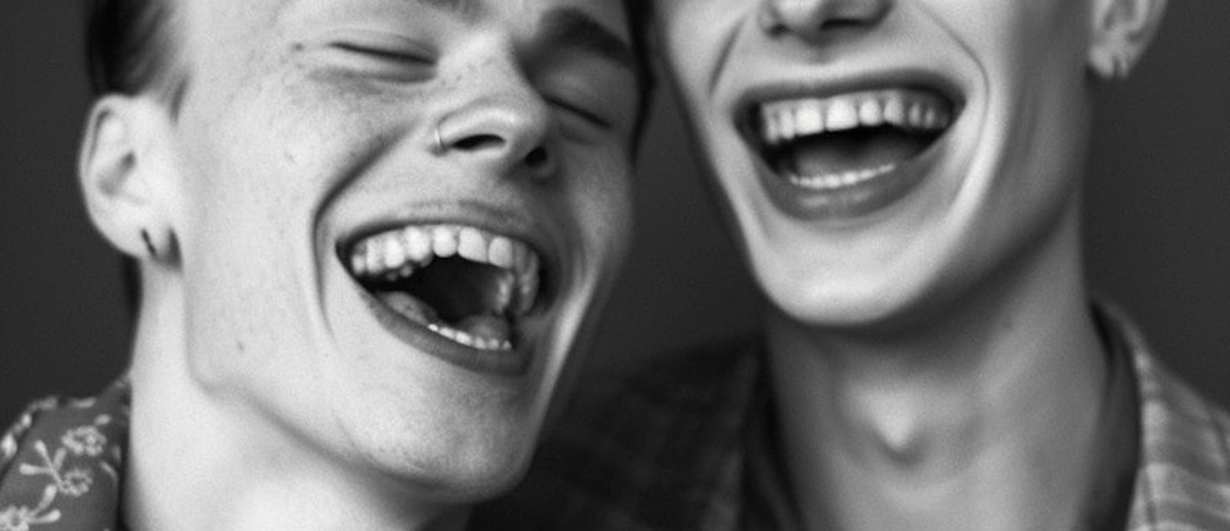 two young men are laughing