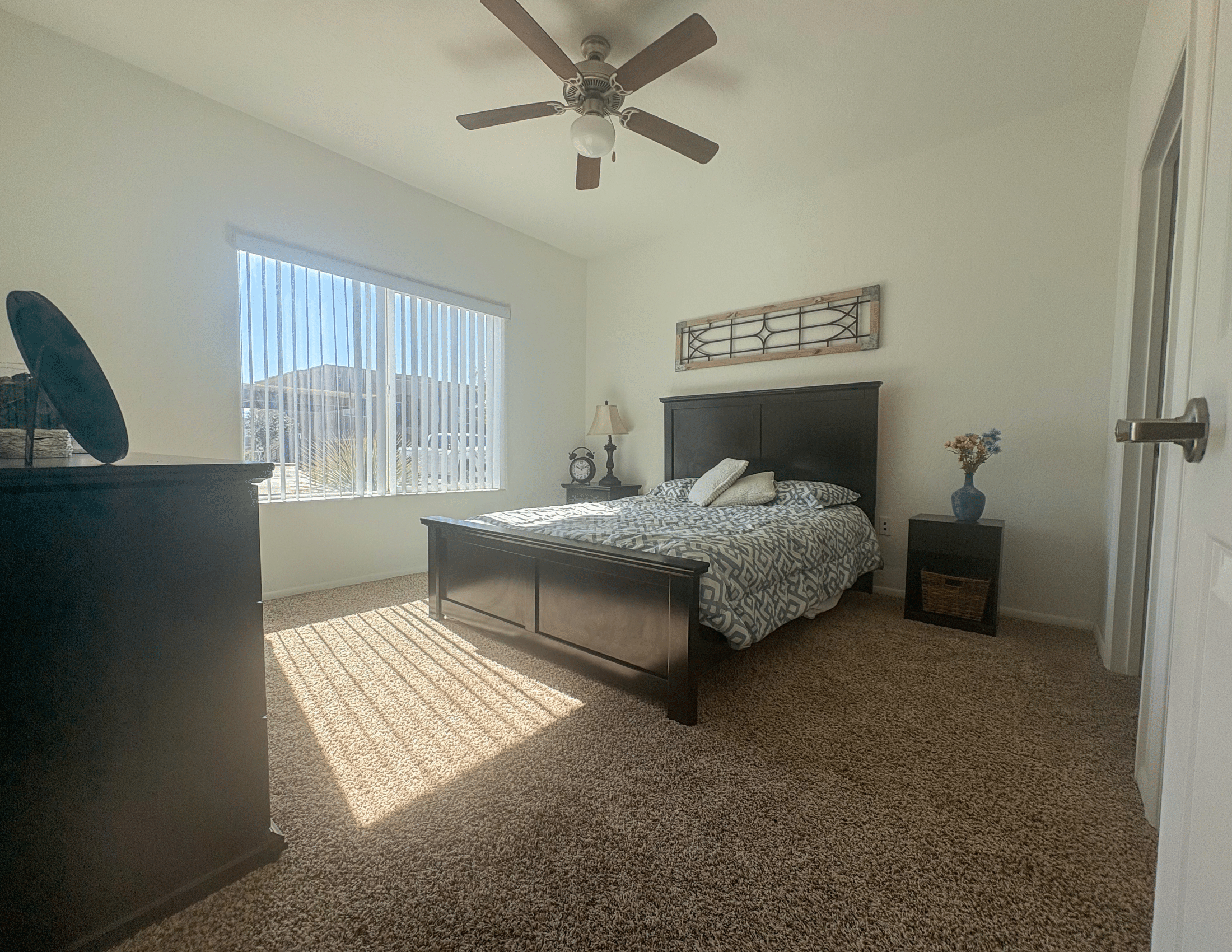 furnished master bedroom with bed and wardrobe