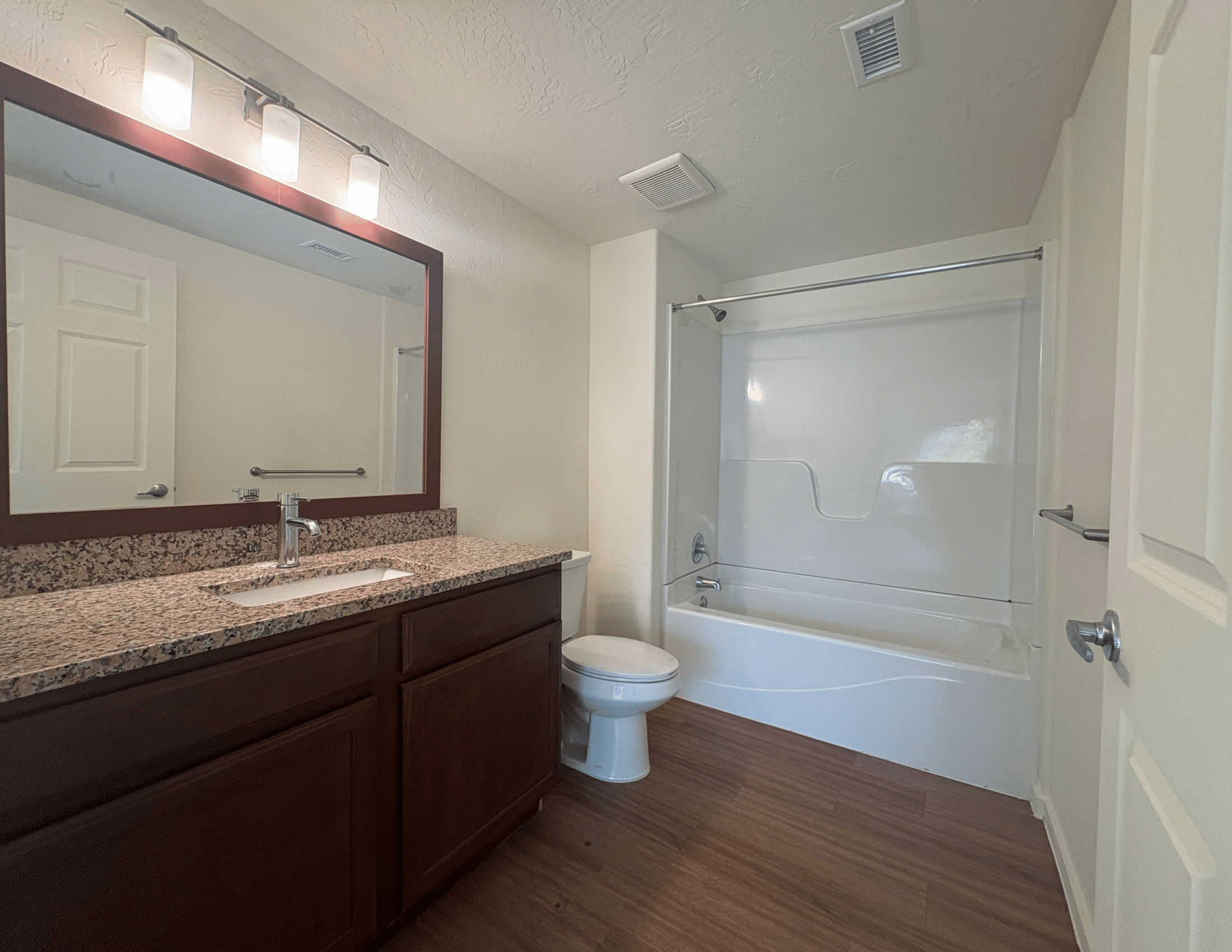 bathroom with vanity mirror and tub shower