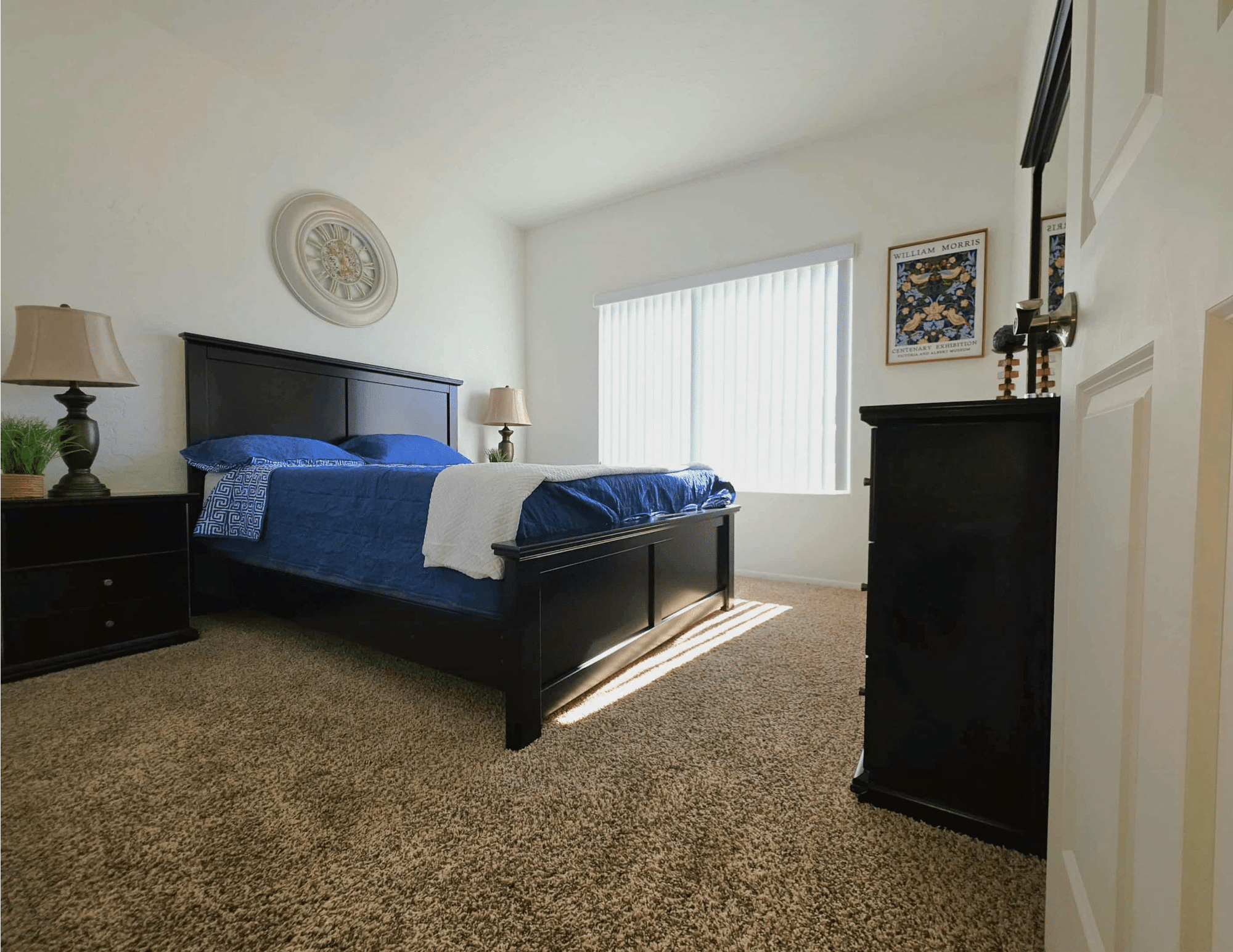 furnished master bedroom with bed and wardrobe