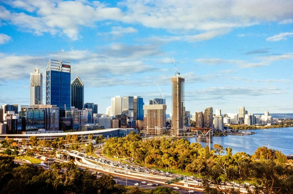Panoramic view of Perth CBD, with skyscrapers, highways, parks and the river