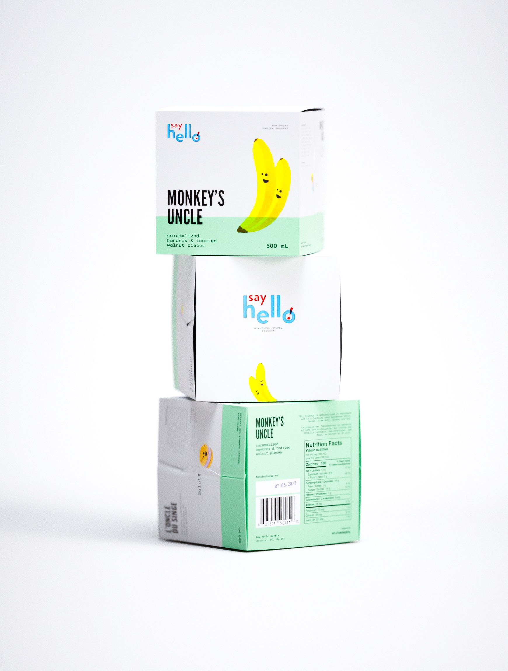Inventive packaging design for Say Hello's Monkey's Uncle beverage featuring expressive banana character illustrations on mint green substrate. Typography-forward design approach demonstrates branding agency capabilities in creating memorable shelf presence through bold headline treatment. Creative studio work showcases strategic color theory application and characterful visual narrative across stackable carton system. Professional packaging design integrates playful brand personality with functional nutrition labeling and sustainable packaging architecture.

